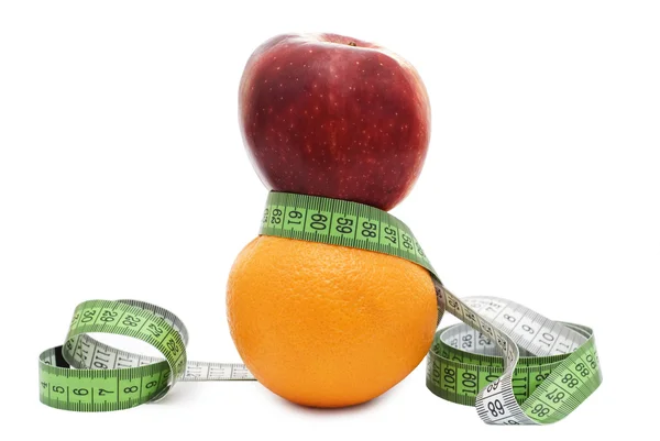 Red apple and orange with tape measure — Stock Photo, Image