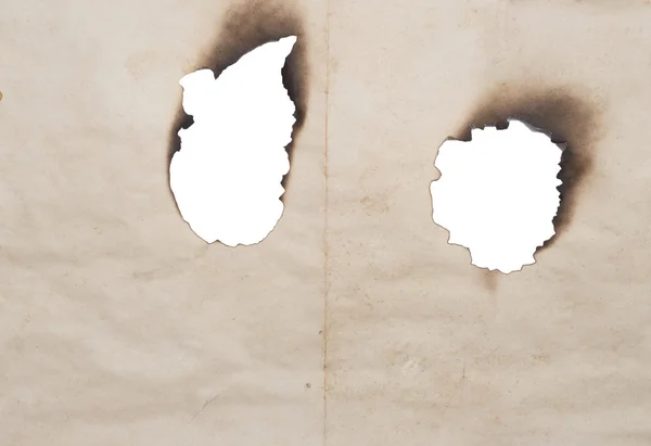 Burnt holes in old paper — Stock Photo, Image