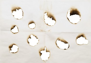 Burnt holes in a paper clipart