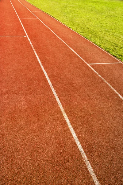 Green grass and running track — Stock Photo, Image