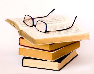 Pile of books and eyeglasses clipart