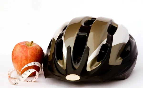 Stock image Bicycle helmet and apple