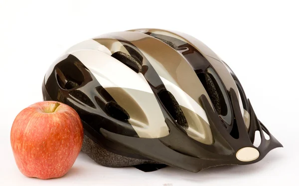 stock image Bicycle helmet and apple