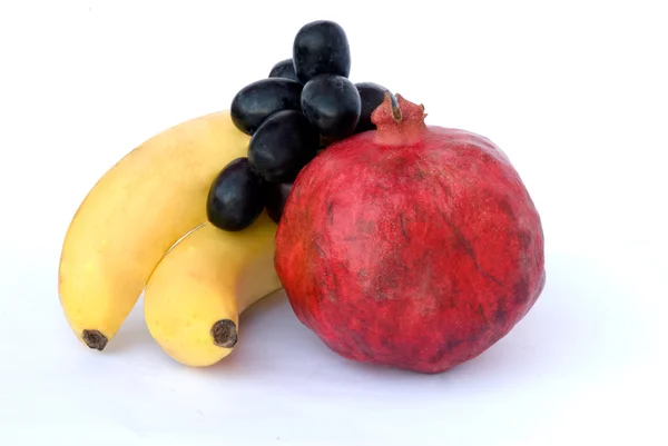 Banana, pomegranate, and grapes — Stock Photo, Image