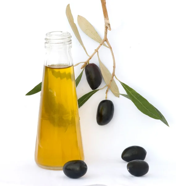 Botella de aceite de oliva y rama de olivo —  Fotos de Stock