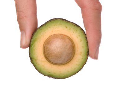 Hand holding section of acocado clipart