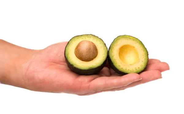 Helften van avocado op palm — Stockfoto
