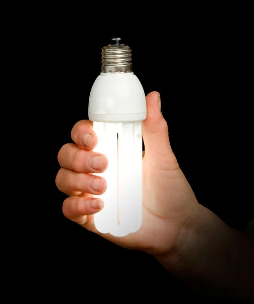 Az energiatakarékos lámpa a kezében — Stock Fotó