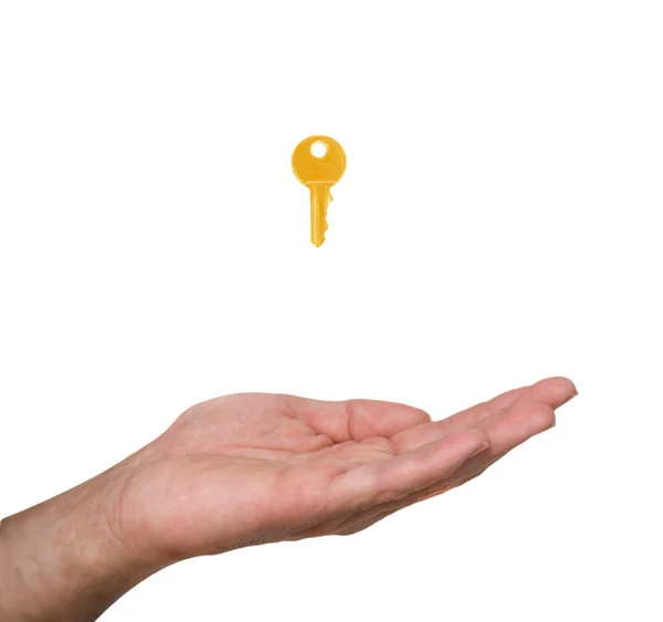 Close up of hand and golden key — Stock Photo, Image