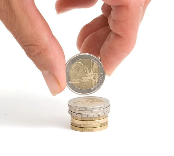 Mano sosteniendo moneda de dos euros — Foto de Stock
