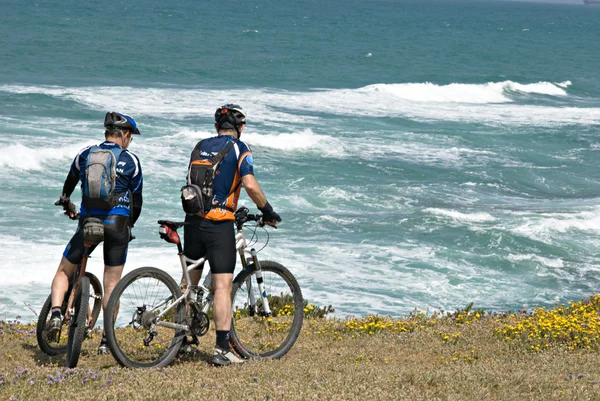 stock image Two cyclists on sea beach