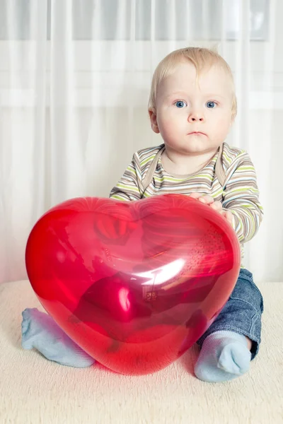 Chico divertido con globo de corazón — Foto de Stock