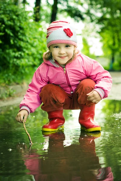 女孩扮演在水坑里 — 图库照片