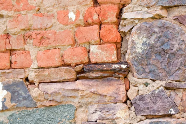 Rock wall fixed with bricks — Stock Photo, Image