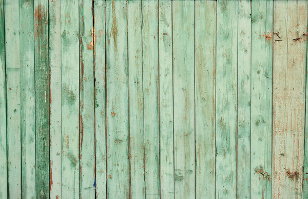 Wooden fence on all background, with traces of a paint