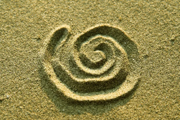 Spiralzeichen im Sand — Stockfoto