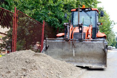 Bulldozer with pile of dirt clipart