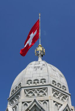 Swiss flag on the tower of Grossmunster clipart