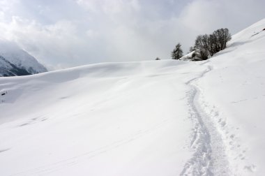 Winter mountain path in Swiss Alps clipart