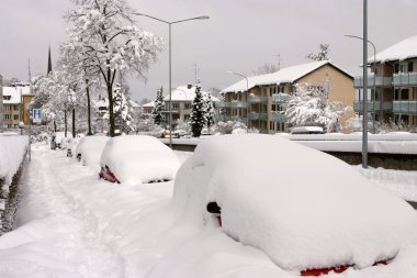 Parked cars buried under snow clipart