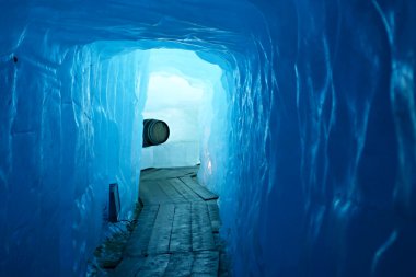 Tunnel in the ice inside Rhone glacier clipart