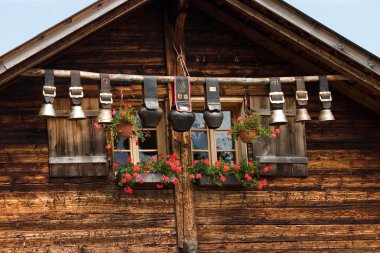 Decorative cow bells under the roof clipart