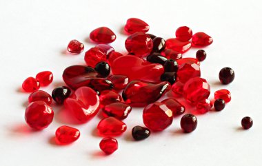 Aassorted red glass beads on white clipart