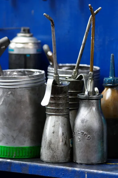 Antique oil cans in a workshop — Stock Photo, Image