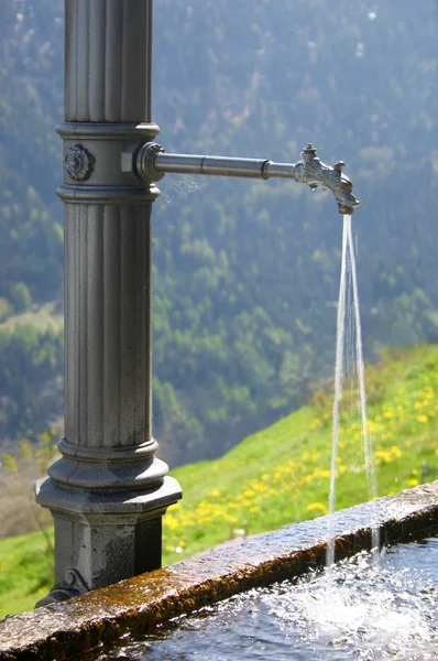 stock image Water fountain in Swiss Alps