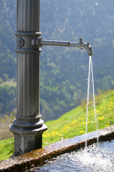 Water fountain in Swiss Alps
