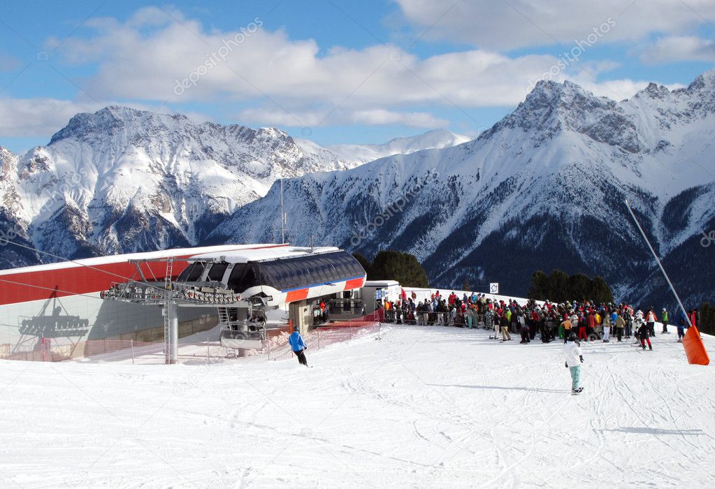 Skiers queing for a chair-lift
