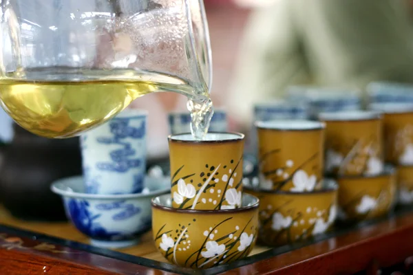 Свежий чай наливают в чайную пару — стоковое фото