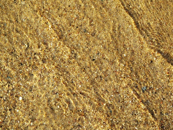 Agua ondulada sobre arena de playa — Foto de Stock