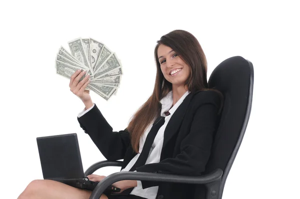 Girl witn netbook and money in chair — Stock Photo, Image