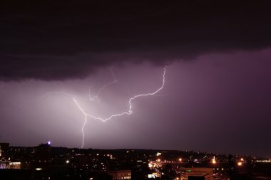 Lightning strike over city clipart