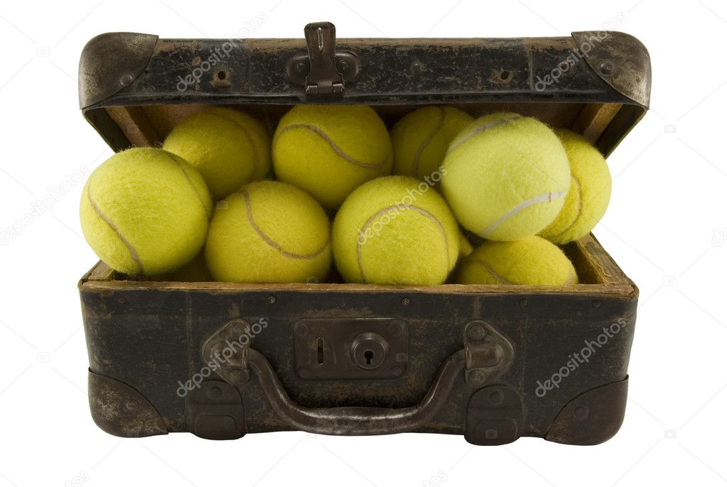 Old suitcase full of tennis balls