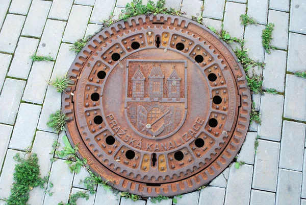 Manhole fechado com emblema em Praga — Fotografia de Stock
