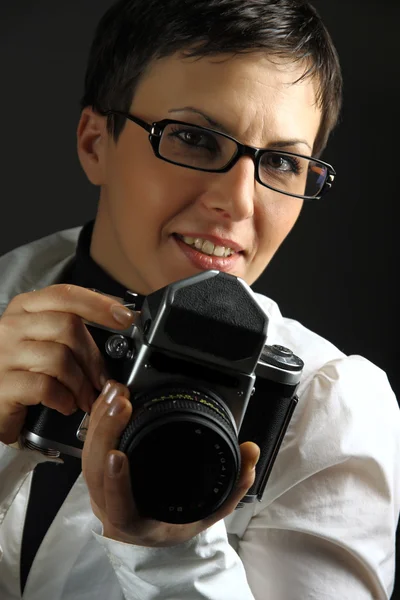 Beautiful young woman with camera — Stock Photo, Image