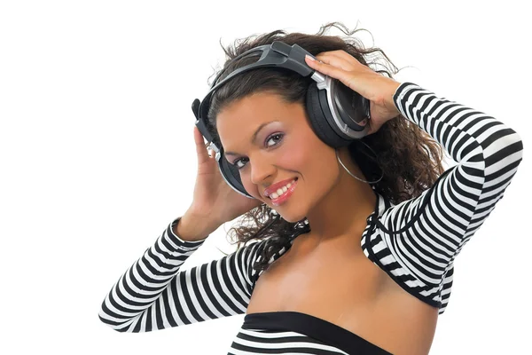 Beautiful curly brunette girl listening music — Stock Photo, Image