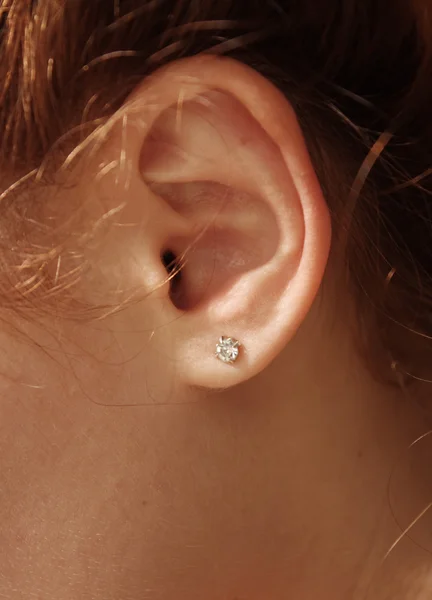 stock image Female ear with diamond earrings