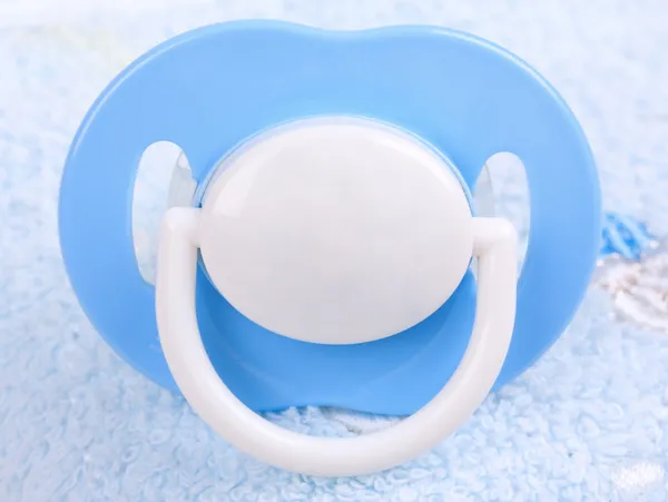 Blue pacifier on towel — Stock Photo, Image