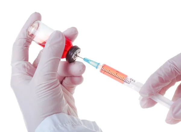 Medic holding a syringe for injection — Stock Photo, Image