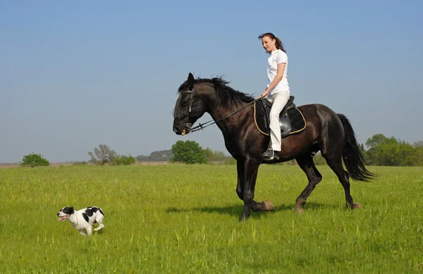 Riding girl and her dog — Stock Photo, Image