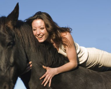 Laughing woman and stallion clipart