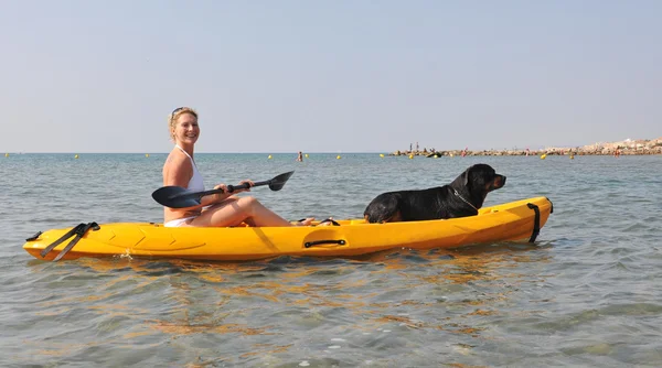 Woman and dog on a kayak — Stock Photo, Image