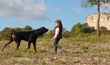 Little girl and rottweiler clipart