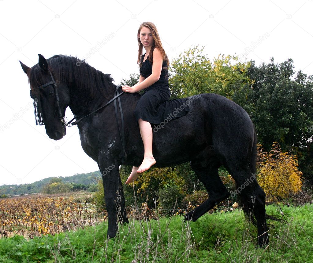 Young woman and her black stallion.