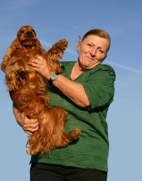 Cocker spaniel and senior woman — Stock Photo, Image