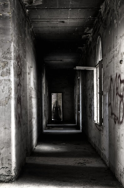 Ghostly apparition at end of corridor in an old abandoned building