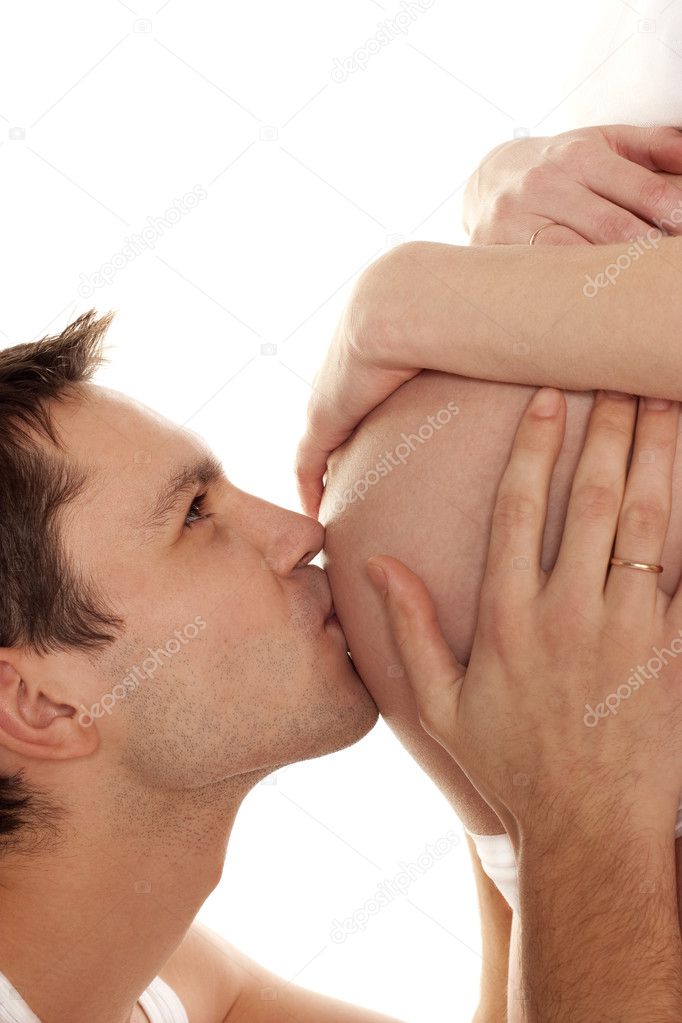 Dad kissing wife's belly